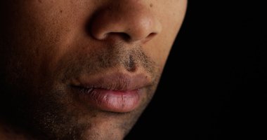 Close up on African man's lips clipart