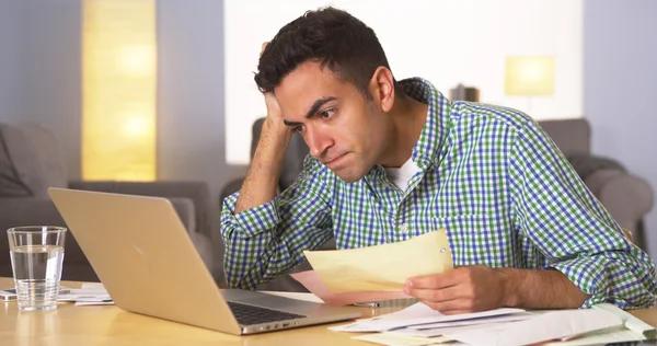 Mexican man feeling frustrated with bills — Stock Photo, Image
