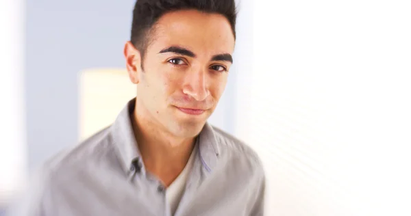 Confident Mexican man standing by window — Stock Photo, Image