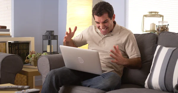 Enthusiastic fan watching his team to victory on laptop — Stock Photo, Image
