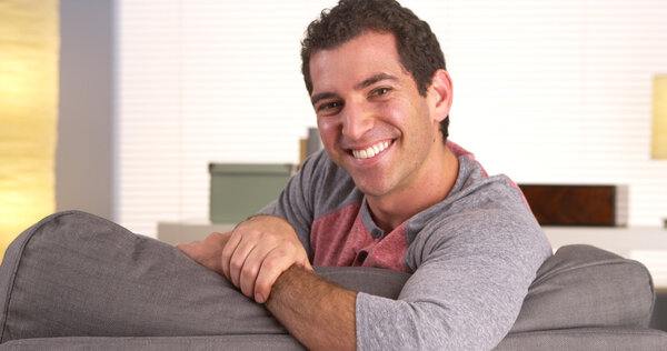 Happy guy lying on couch