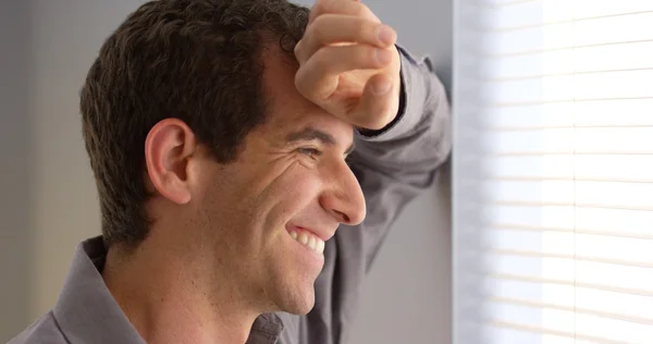 Close up of businessman looking out window — Stock Photo, Image