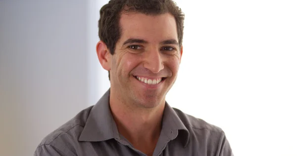 Casual businessman standing in office looking at camera — Stock Photo, Image