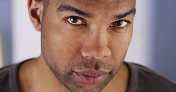 Black man looking up at camera — Stock Photo, Image