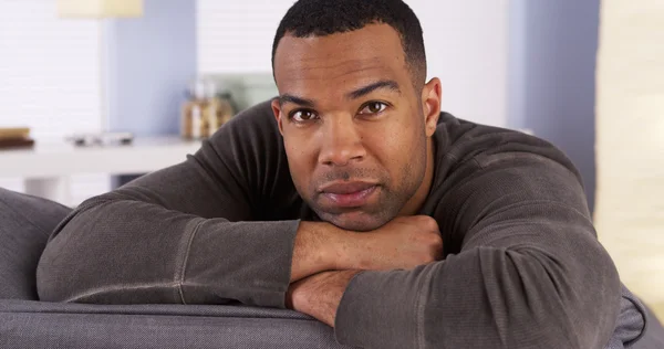 Black man resting on couch — Stock Photo, Image