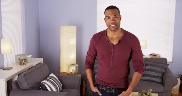 Handsome Black man standing in living room — Stock Photo, Image