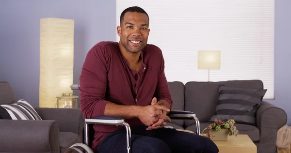 Happy African man sitting in wheelchair smiling — Stock Photo, Image