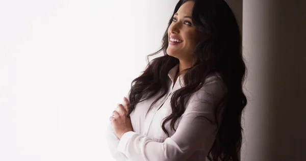 Cute Mexican businesswoman laughing by window — Stock Photo, Image