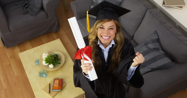 Happy young woman graduate holding diploma — Stock Photo, Image