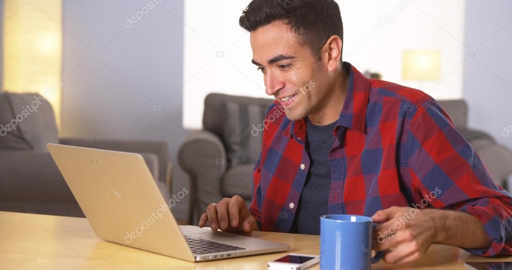Puerto Rican man using laptop at desk