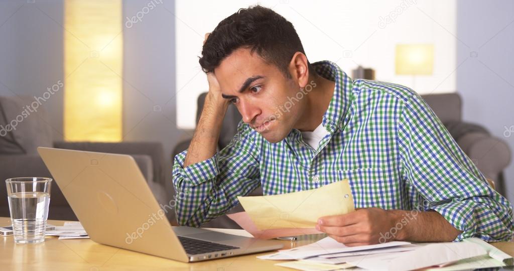 Mexican man feeling frustrated with bills