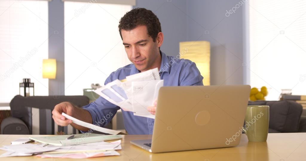 Man going over his finances at home