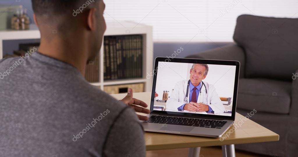 Black patient discussing health problems with doctor online