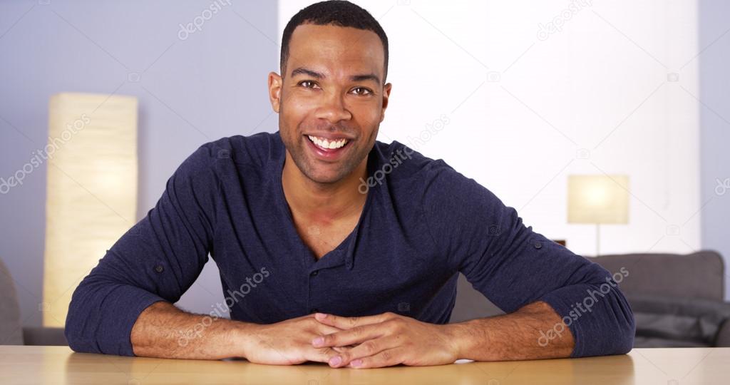 Black man smiling and talking