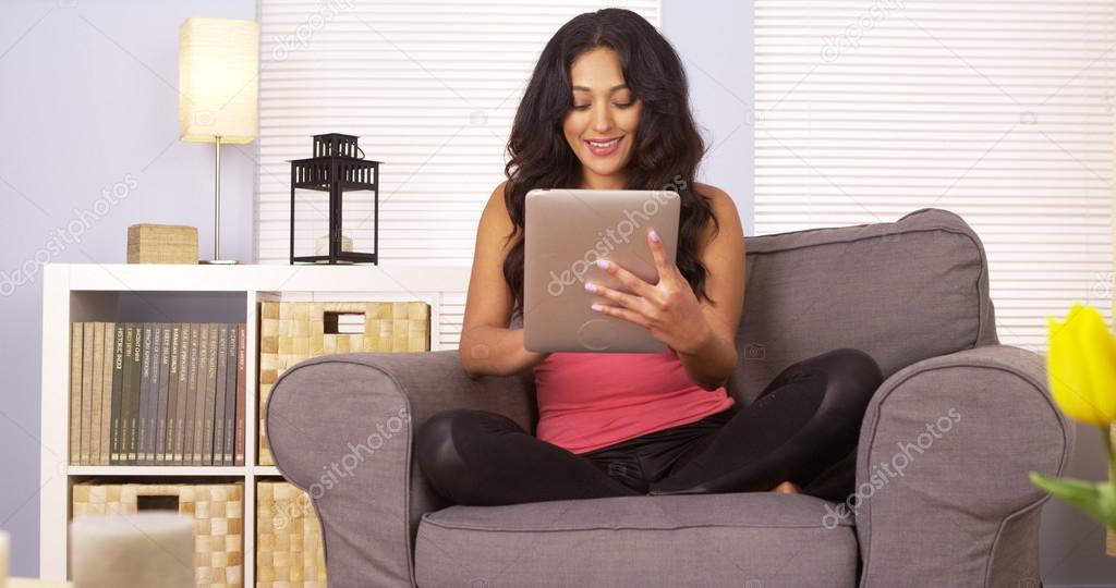 Hispanic woman surfing the web on tablet