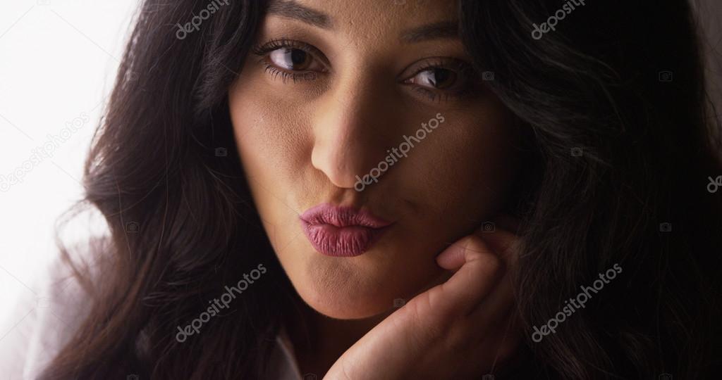 Sultry Mexican woman blowing kisses at camera