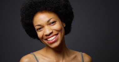Slow pan up African woman laughing and smiling clipart