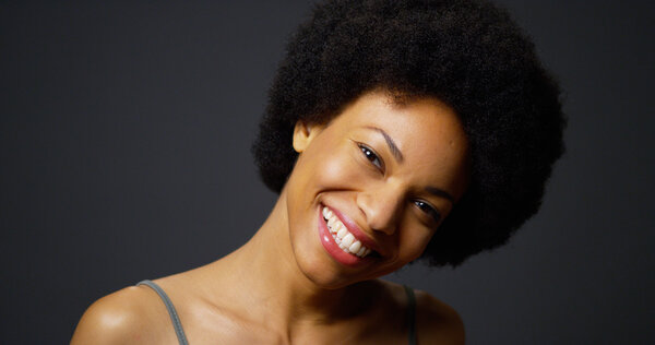 Slow pan up casual black woman laughing and smiling