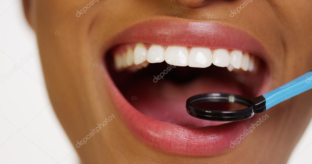 Mouth and teeth of black woman in dental examination