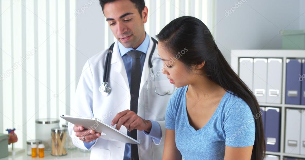 Asian patient talking with her doctor about her test results