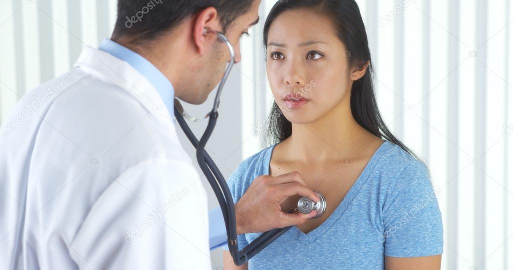 Mexican doctor listening to patient's heart