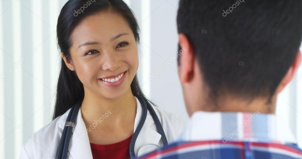 Asian doctor talking to patient