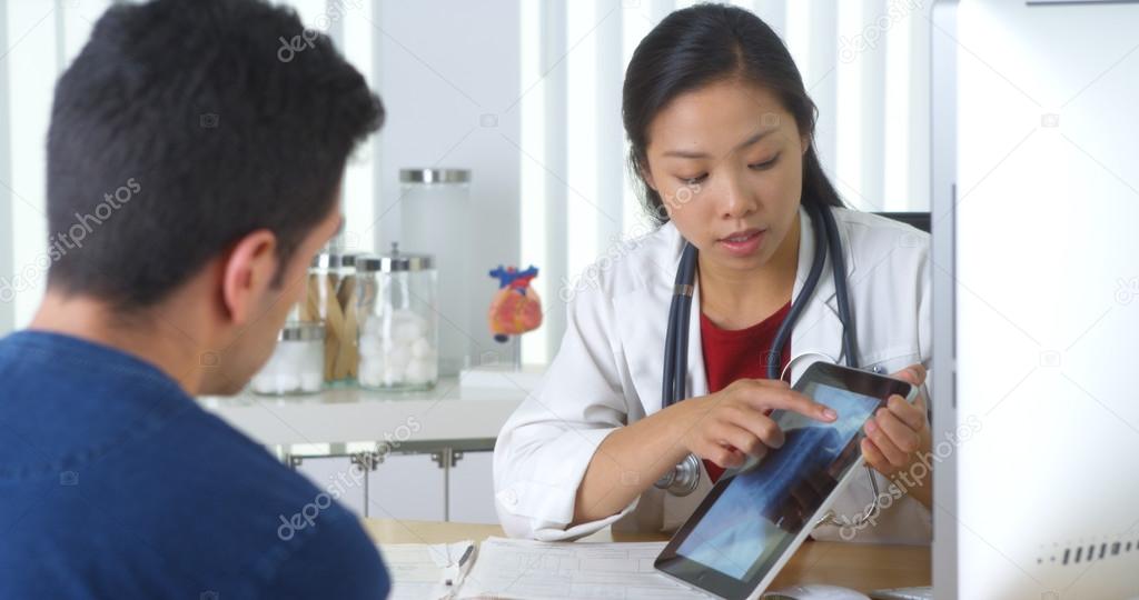 Chinese doctor explaining xray to patient