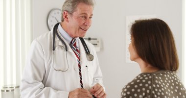 Friendly doctor having a conversation with senior patient