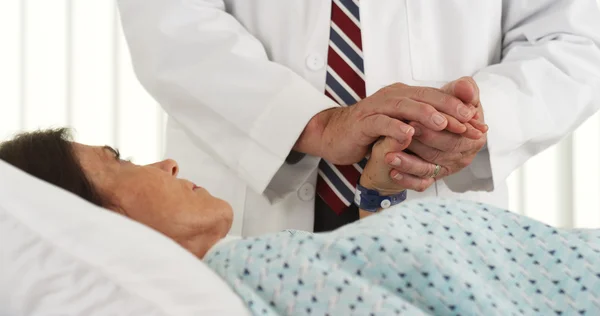 Doctor holding patient's hand and comforting her — Stock Photo, Image