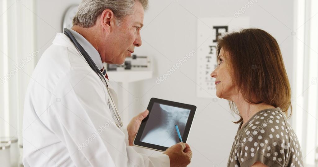 Doctor explaining xrays to elderly patient