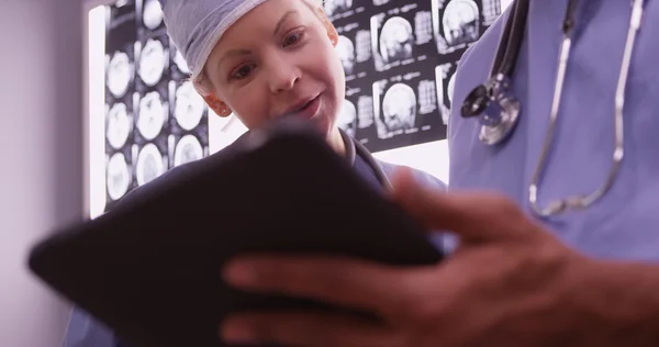 Doctors using devices in the office — Stock Photo, Image