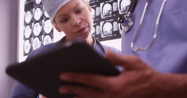 Doctors using devices in the office — Stock Photo, Image