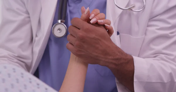 Closeup of African doctor holding patient's hand — Stock Photo, Image