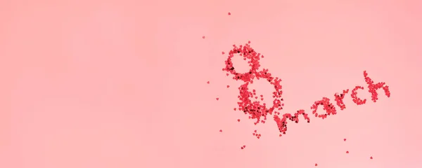 Pembe arka planda 8 yürüyüş şeklinde parıldayan kırmızı harfler. Mutlu Uluslararası Kadınlar Günü konsepti yatıyordu.