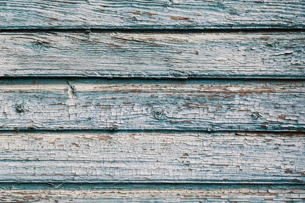 Antigua pintura agrietada azul sobre fondo de madera — Foto de Stock