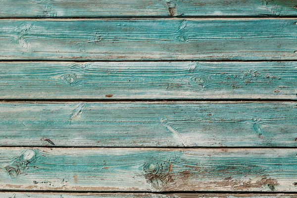 Antigua pintura agrietada azul sobre fondo de madera — Foto de Stock
