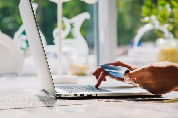 Femme utilisant un ordinateur portable avec carte de crédit à la main — Photo