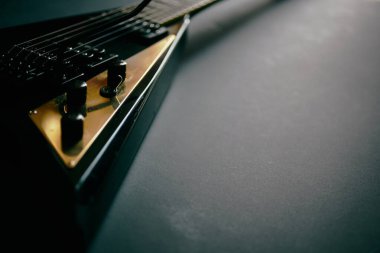 Koyu grunge arka planında siyah V biçimli elektro gitar.