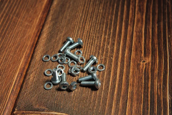 Screws on the wooden background — Stock Photo, Image