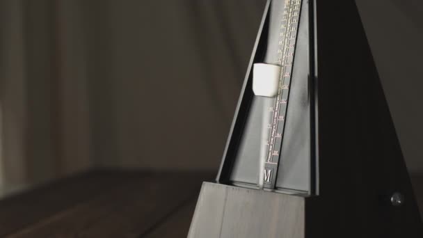 Vintage metronome, on a dark background. — Stock Video