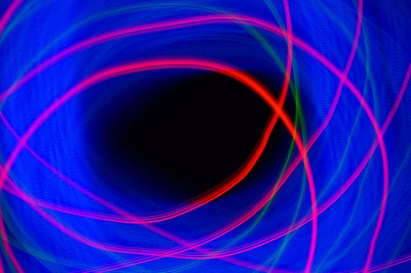 Blue fog on black background with red smudges. Luminous fog, blue glow with red lines. Black background with graphic abstract elements in space.