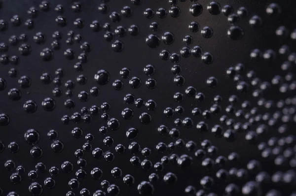 Air bubbles in the water. Metallic bubbles in a glass of water. Soda water in close-up, on dark background.