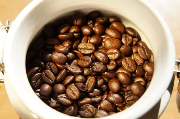 Coffee beans on close-up. Roasted beans of strong natural coffee. Preparing coffee for drinking.