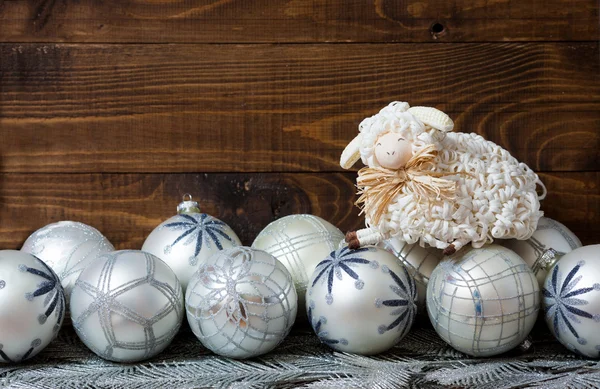 White christmas balls and sheep with wooden background — Stock Photo, Image