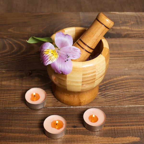 Wooden bamboo pounder with candles — Stock Photo, Image