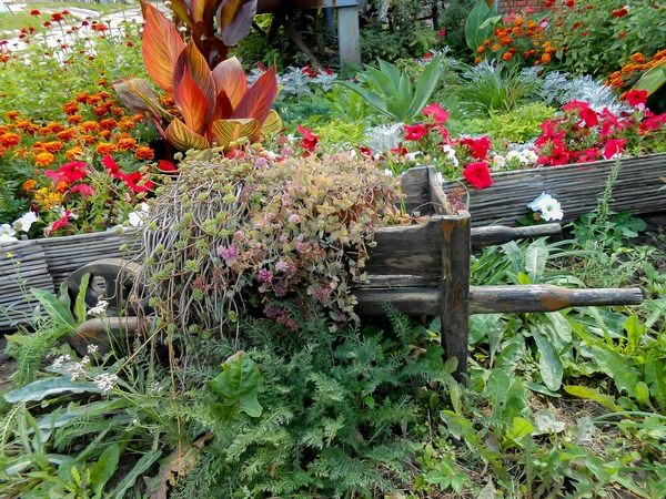 Photo manipulation  bed wagon with multicolor flowers — Stock Photo, Image