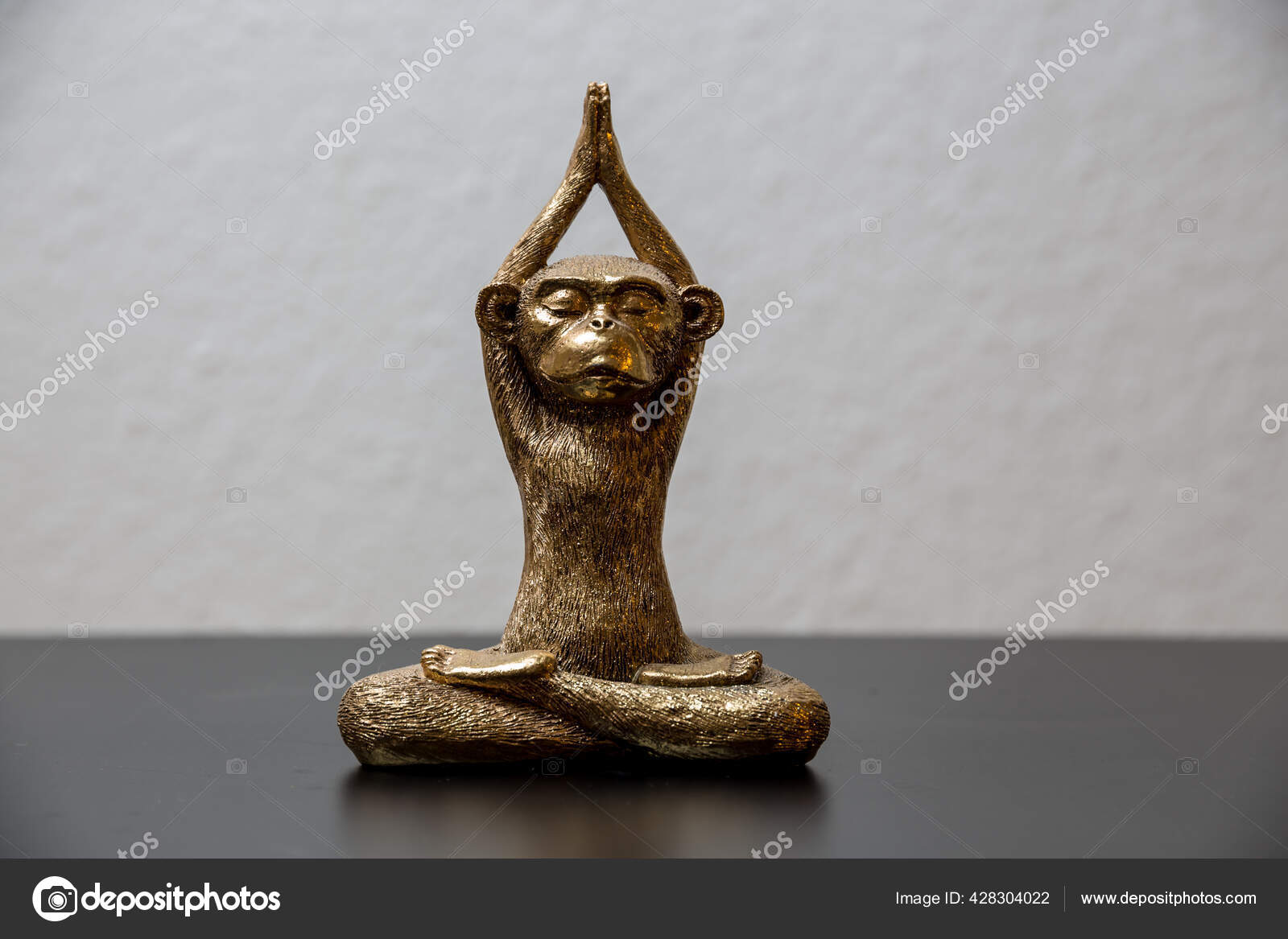 Gold Colored Meditating Monkey Statue Sitting Black Surface Background