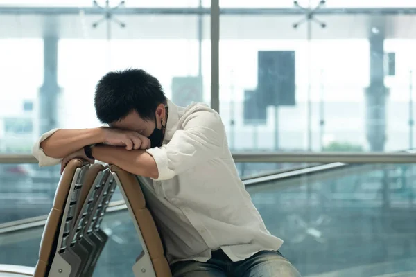 Man with luggage in airport terminal. Social distancing, International airport, on holiday, Corona virus, passenger wearing protective mask, after Covid-19, outbreak, Finding solitude