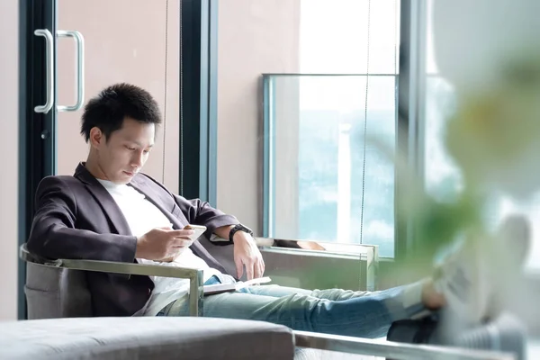 Happy Asian man with luggage or suitcase ready to travel for his holidays, traveller male casual on vacation concept.