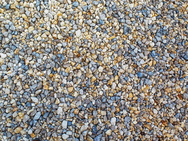 Packed gravel, laid in the foundation of the road.
